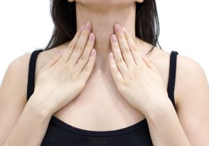 a woman suffering from symptoms of an overactive thyroid gland