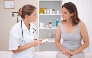 a woman speaking to a nurse about vaginal discharge and vaginal infection