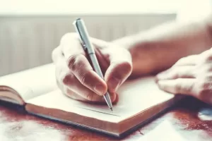 a man with essential tremor- he has a hand tremor as he is writing