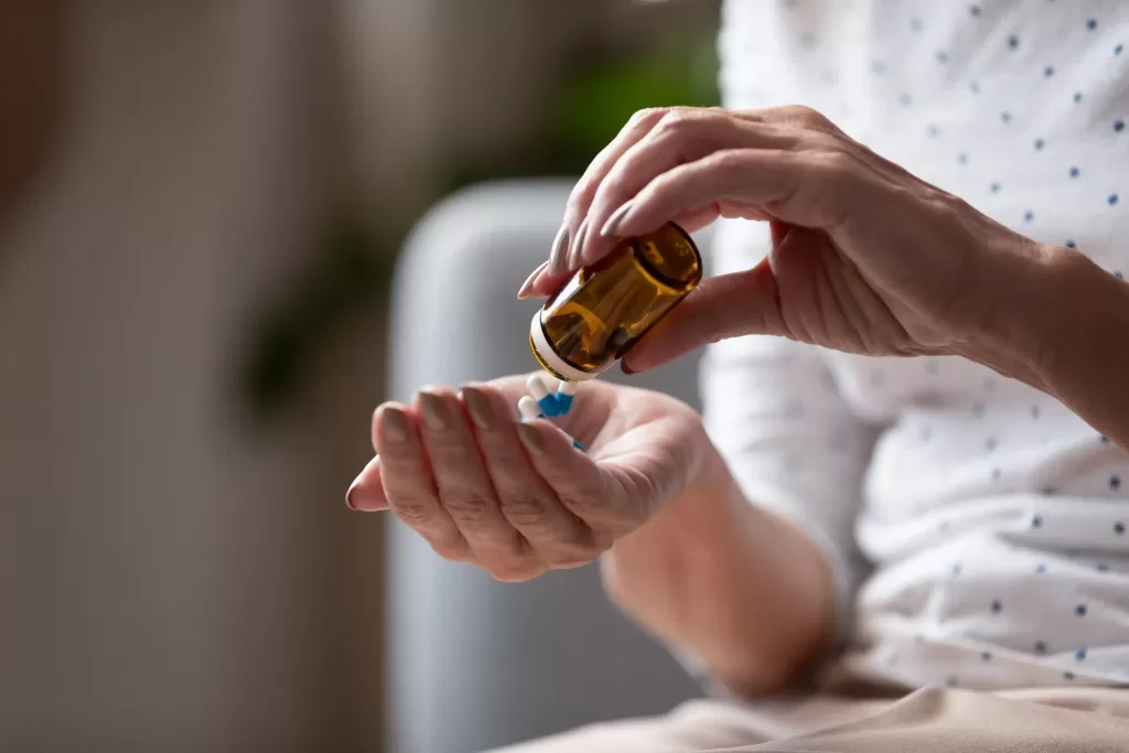 A person taking a medication that could cause night sweats as a side effect