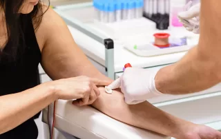 A swab is pressed onto the injection site during the blood collection to test for HIV